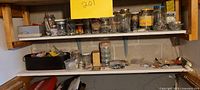 Wide view of shelves with jars and containers filled with screws, nails, and fasteners