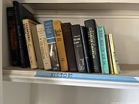 Books arranged on shelf labeled 'HISTORY' showing variety of history books and biographies.