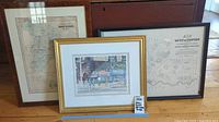 Photo shows three framed prints. Left is a vintage map of South Scituate, middle is a Boston street scene color illustration, right is a map of Town of Norwell.