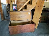 Open vintage wooden chest showing dovetail joints and wear