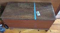 Top view of vintage wooden hope chest showing worn wood surface with scratches and fading.