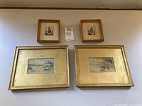 Front view of 4 framed prints: 2 smaller Hummel prints and 2 larger landscape prints