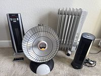 All four items together: Holmes oil filled heater, Presto Heat Dish heater, DeLonghi tower heater, Seville Classics fan with remote visible