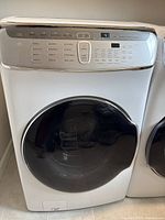 Full front view of the Samsung washer showing main front-loading door and adjacent unit.