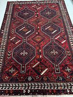 Top-down view of entire red Persian Shiraz rug on floor