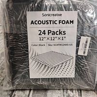 Front view of sealed plastic package showing label for Sonicreative acoustic foam 24 packs 12"x12"x1" black.