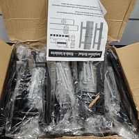 Photo of the 30 black handles packaged in plastic inside a box with installation instructions visible.