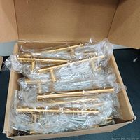 Box containing 30 brand new steel gold-finished handles individually packaged.