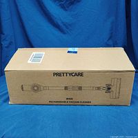 Closed cardboard box packaging labeled PRETTYCARE W400 Rechargeable Vacuum Cleaner with device sketch printed on side.