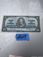 Front side of the 1937 Canadian five-dollar bill showing King George VI portrait, serial numbers, and bilingual denomination text.