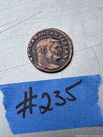 Obverse side of an ancient coin showing head profile and inscriptions