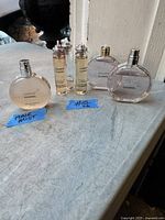 Wide view showing all six bottles with two small ones, two medium round ones and one labeled Hair Mist on the left.