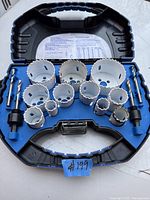 Set of Mastercraft hole saw cutting tips in an open blue and black carrying case showing multiple sizes of white cutting tips.