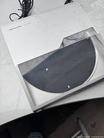 Top view of the Realistic LAB-1500 turntable with clear dust cover showing some surface marks.