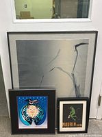 Group photo showing the three framed lithographs including the large abstract piece, the Indigenous American style print, and the Maurin Quina print.