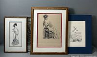 Three framed art prints arranged side by side: a seated woman, a standing woman, and a botanical still life.