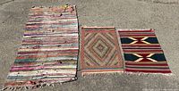 Wide view showing all three hand woven mats laid out on concrete. Colors and patterns vary by size.