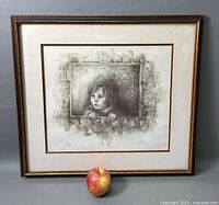 Framed lithograph of a young girl in a classic frame, shown with an apple for scale.