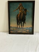 Front view of framed print showing Indigenous American man on horse, arms outstretched towards sky, with mountainous landscape background.