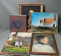 Group display of the 5 art pieces including pastel and oil paintings arranged with framed portraits, church landscape, abstract globe, and tree painting.