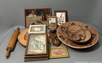 Collection of wooden decorative items including baskets, trays, framed pictures, and rolling pin.