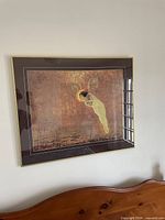 Framed picture showing the full angelic figure against textured warm background