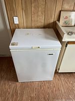 Front view of the white small chest freezer with closed lid showcasing exterior condition and dimensions.