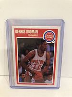 Front of the 1989 Fleer Dennis Rodman basketball card in protective case showing player image, team logo, and name.