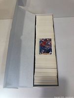 Photo of the open white box filled with stacks of 1991 Upper Deck baseball cards showing one card on top.