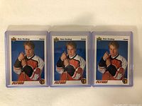 Front side of 3 Peter Forsberg rookie hockey cards in protective cases showing identical images in hockey uniform.