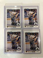 Four Curtis Joseph rookie cards front view, in protective cases, showing Curtis Joseph in St. Louis Blues goalie uniform.