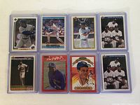 Front view of 8 Ken Griffey Jr baseball cards in individual protective cases arranged in 2 rows of 4.