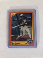 Front view of 1990 Score Eric Lindros baseball card showing batting action.