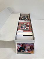 Full box of 1989/1990 Pro Set football cards organized with labeled dividers in a white protective box.