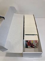 Open white collector's box containing hundreds of 1991 Upper Deck hockey cards in near mint condition, visible from top view showing neatly stacked cards with some player images visible on card fronts.