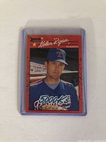 Front view of 1990 Donruss Nolan Ryan 5000 K's error baseball card in protective plastic sleeve showing player image and error mark.