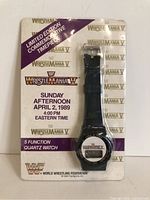 Front photo showing the complete watch sealed in original packaging with event details and function specifications.