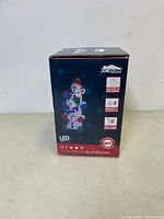 Box front showing brand Joiedomi, features including LED lights, inflates in seconds, suitable for indoor and outdoor use, height 6ft, and social media handle.