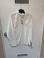 Front view of the Johnnie-O white long sleeve shirt with half-zip, showing subtle patterned fabric and tag intact.