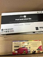Box top view showing Art3d peel and stick tile pack with product info and warnings.