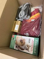 Top view showing boxed contents: pet pads, outdoor jacket, jump rope, and small box.