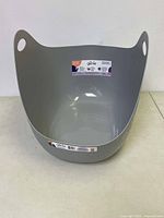 Grey plastic Litter Genie cat litter disposal bin front view showing label and open top