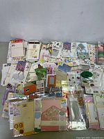 Full view of lot with bundled sticker sheets, keychains, cards, washi tapes, and other stationery items