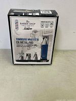 Front of box showing brand, product name, and images of the trimmer and attachments
