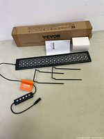 Photo of the Vevor LED aquarium light panel, control box with buttons, adjustable black metal mounting brackets, original instruction manual, and cardboard box.