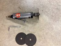 Ingersoll Rand 3-inch air cut-off tool, two cut-off discs, and L-shaped wrench on concrete floor.