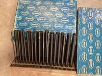 Photo showing 28 steel centering punches in a wooden holder with size markings, blue Links box in background.