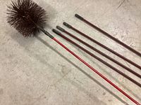 Chimney brush set laid out showing brush head and five threaded rods on concrete floor