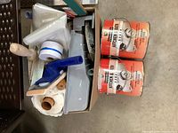 Two one-gallon cans of Cloverdale Kitchen & Bath Kitchen & Bath Acrylic, one eggshell and one semi-gloss finish, both off-white, with handles for carrying.