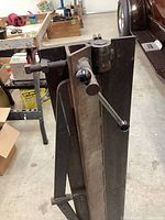 Photo showing the top clamp and tightening handle of the PanBrake metal bender, focusing on the screw bolt and rotating handle.